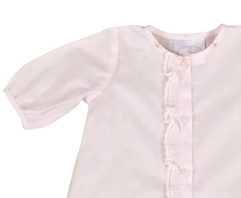 Light pink baby dress with short sleeves on a white background