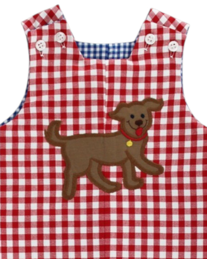 Red and white checkered apron with a brown dog applique on a white background