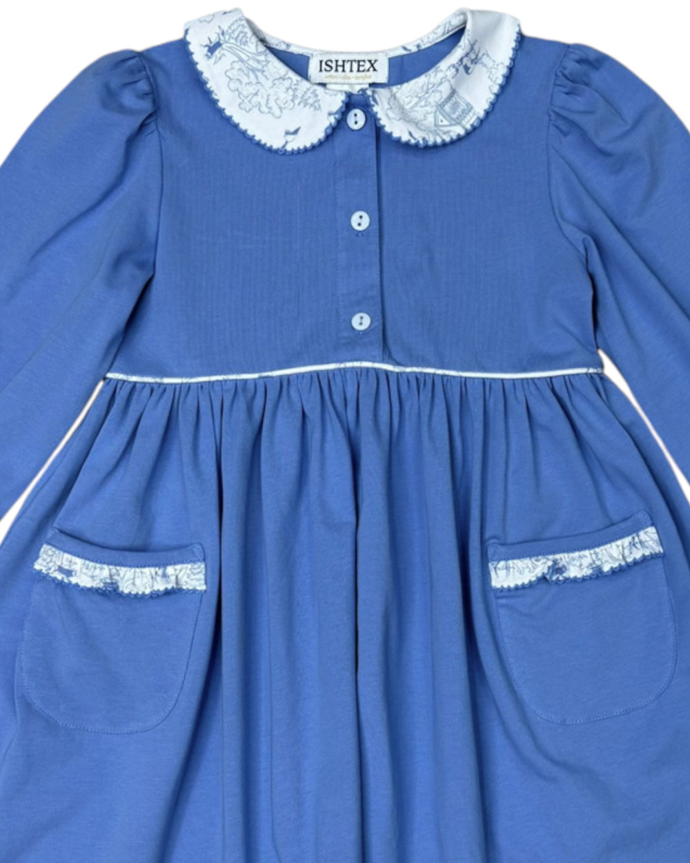 Blue dress with lace details and 'ISHTEX' branding on a white background