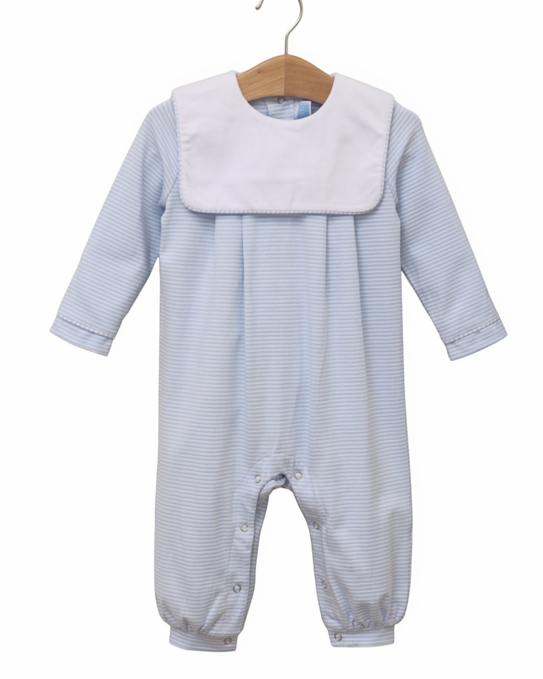 A baby long-sleeve footless romper with a white bib collar, featuring fine light blue and white stripes, hanging on a wooden hanger against a white background, that store