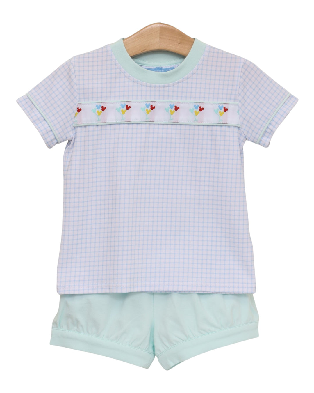 A baby girl's two-piece outfit consisting of a short-sleeve top and matching bloomers. The top is white with a very fine pale pink gingham check, featuring a decorative horizontal band across the chest with embroidered pastel flowers, that store