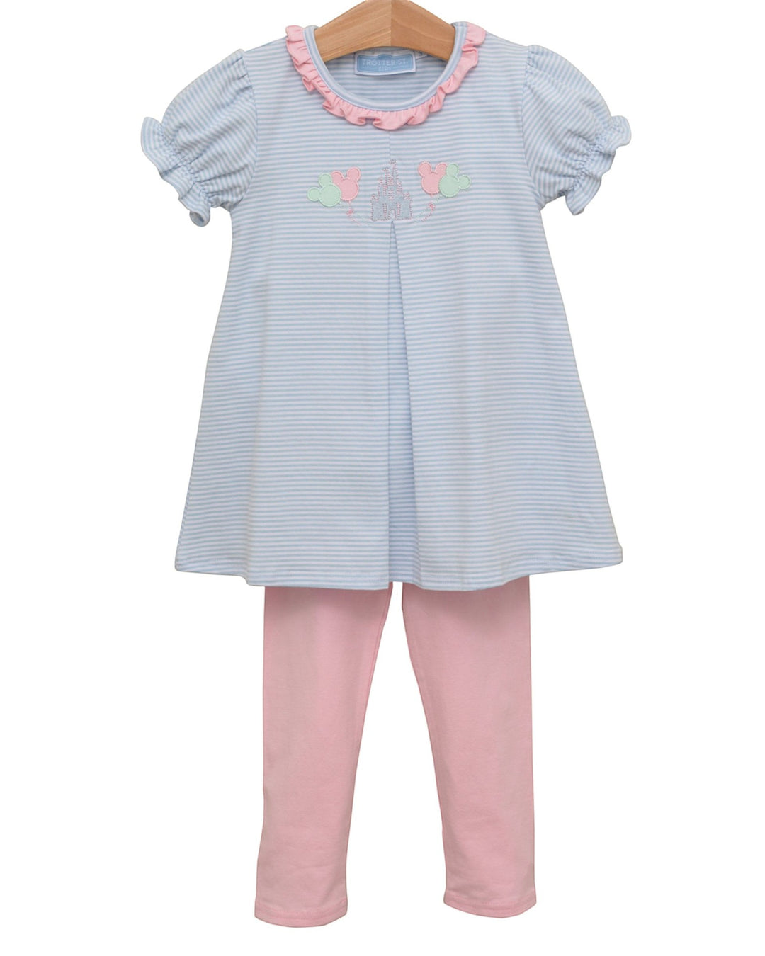 Children's outfit with striped dress and pink pants on a white background