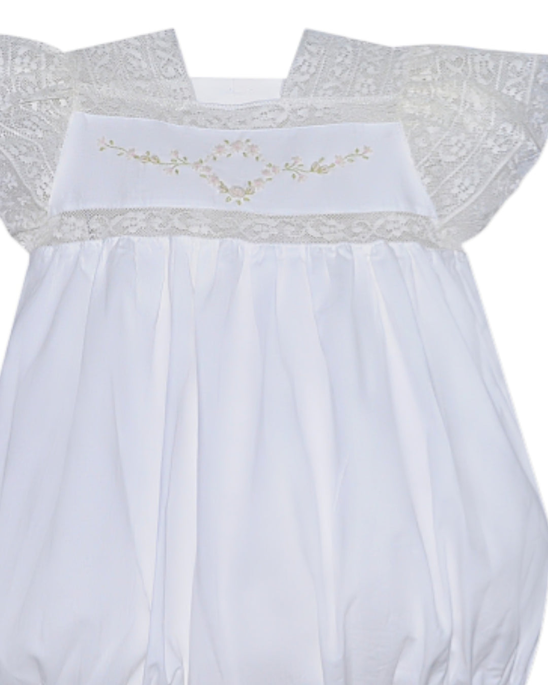 White baby dress with lace details on a white background