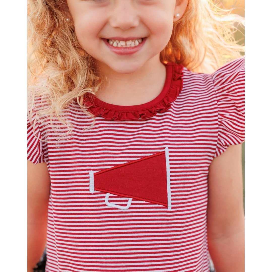 Child wearing a red and white striped dress with a red pocket detail.