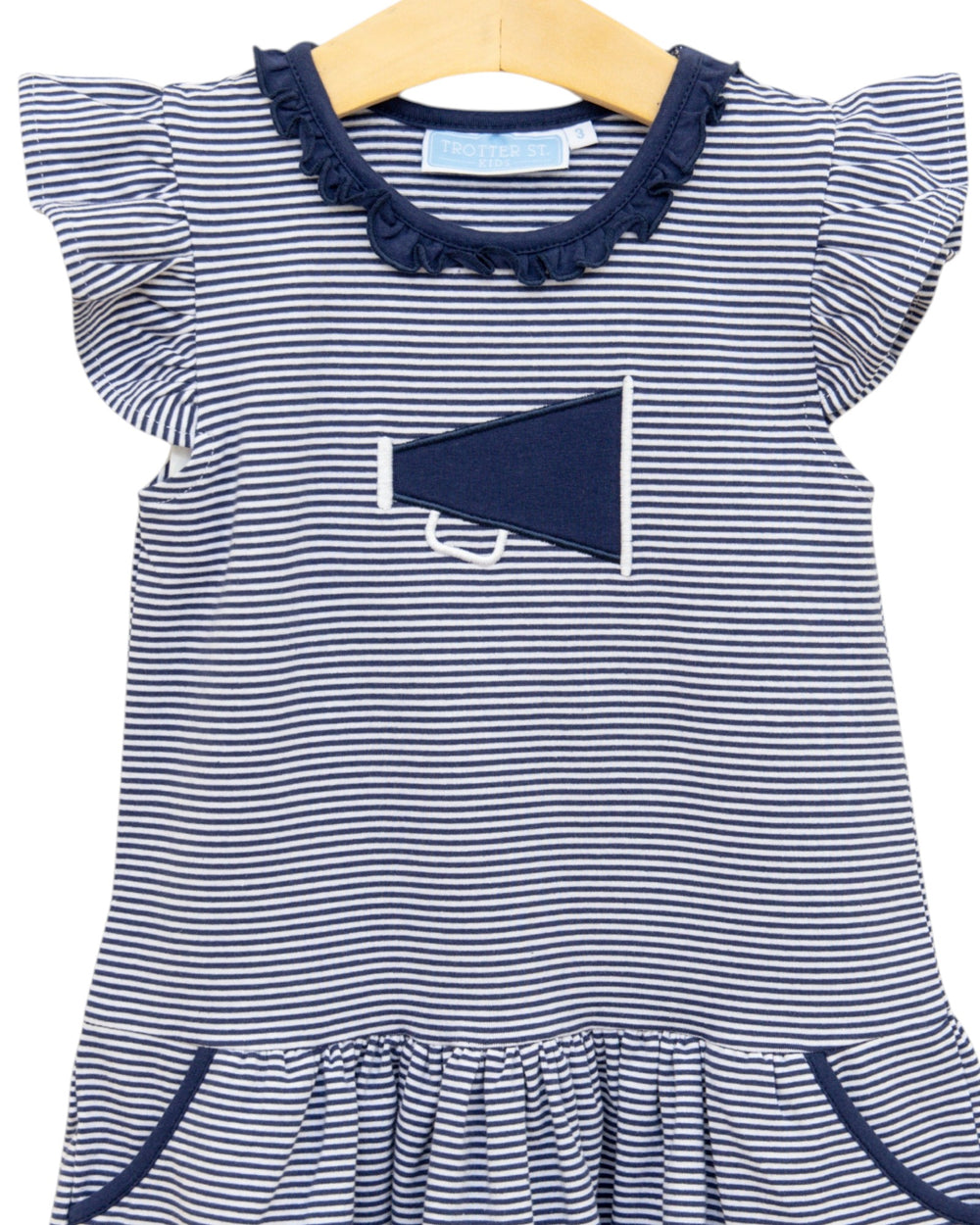 Navy and white striped dress with a megaphone design on a hanger