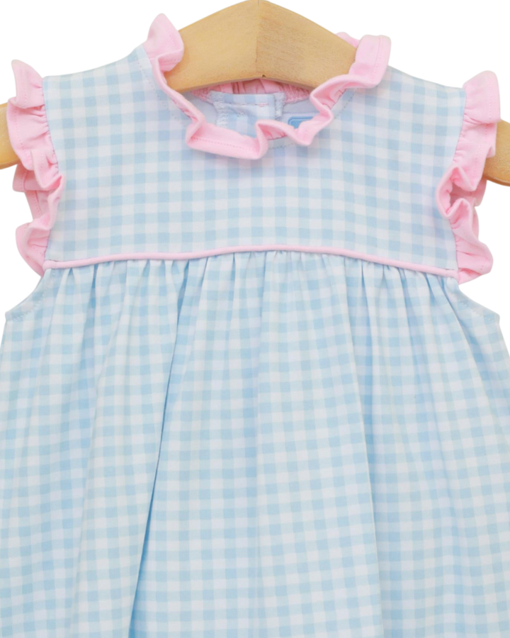 Blue checkered dress with pink ruffles on a hanger
