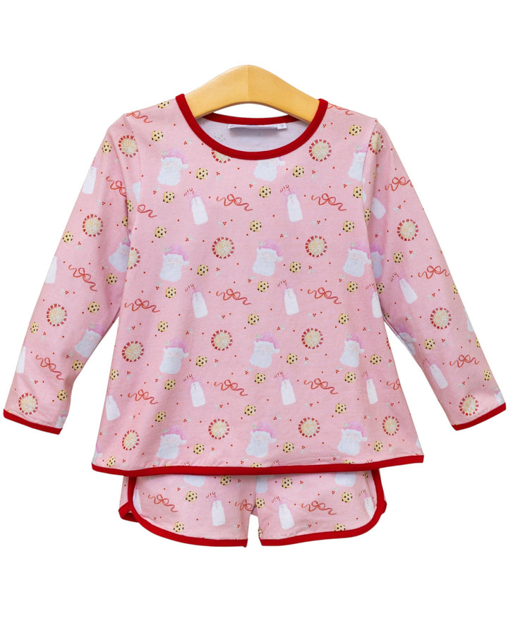 Pink children's pajama set with bottle and flower pattern on a hanger