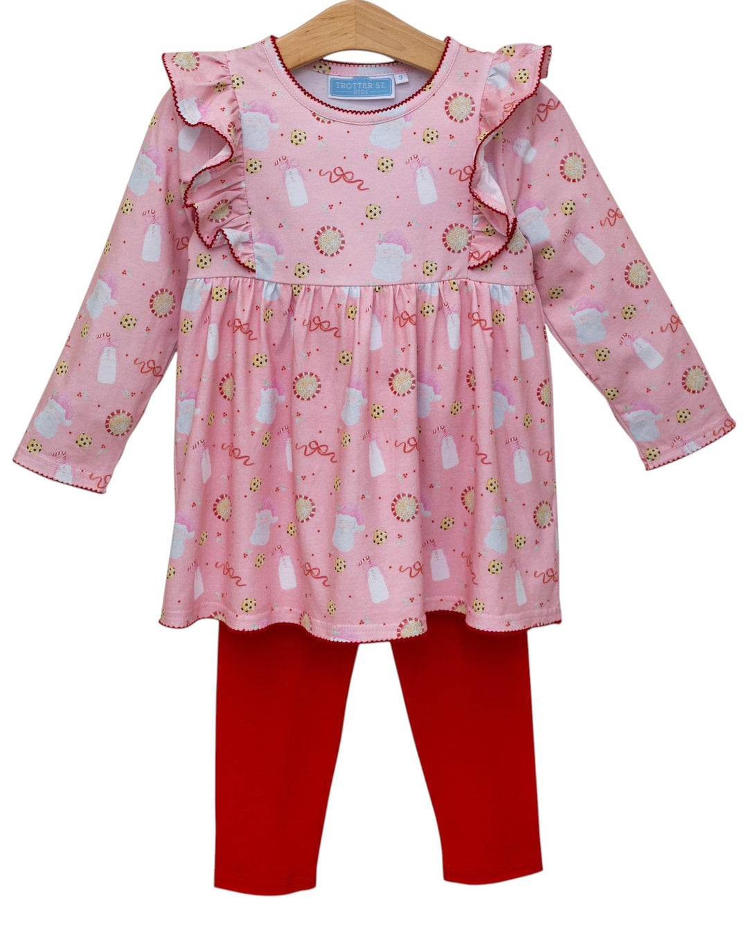 Pink patterned top and red pants on a hanger with a white background