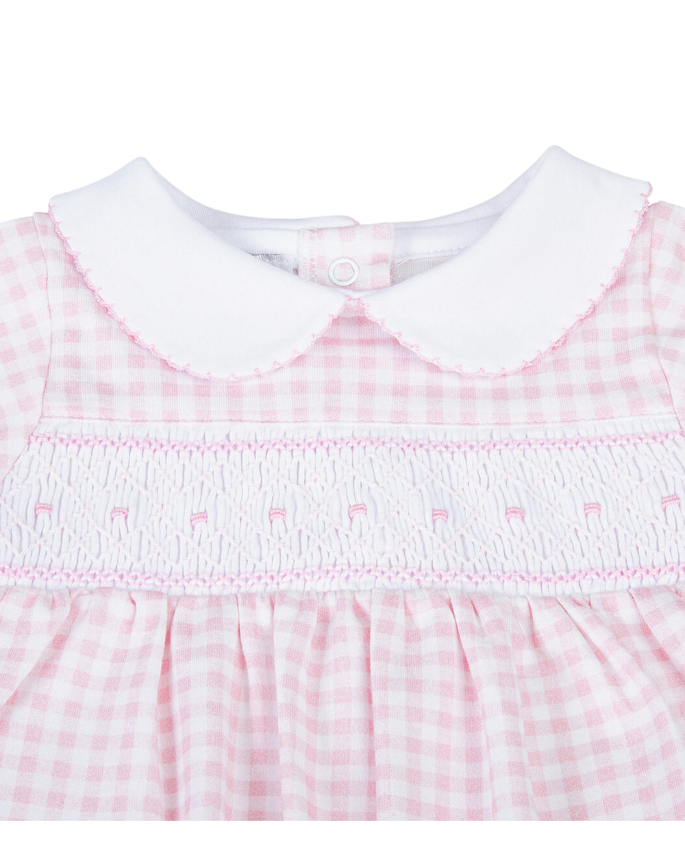 Close-up of a baby dress with pink and white checkered pattern and white collar.