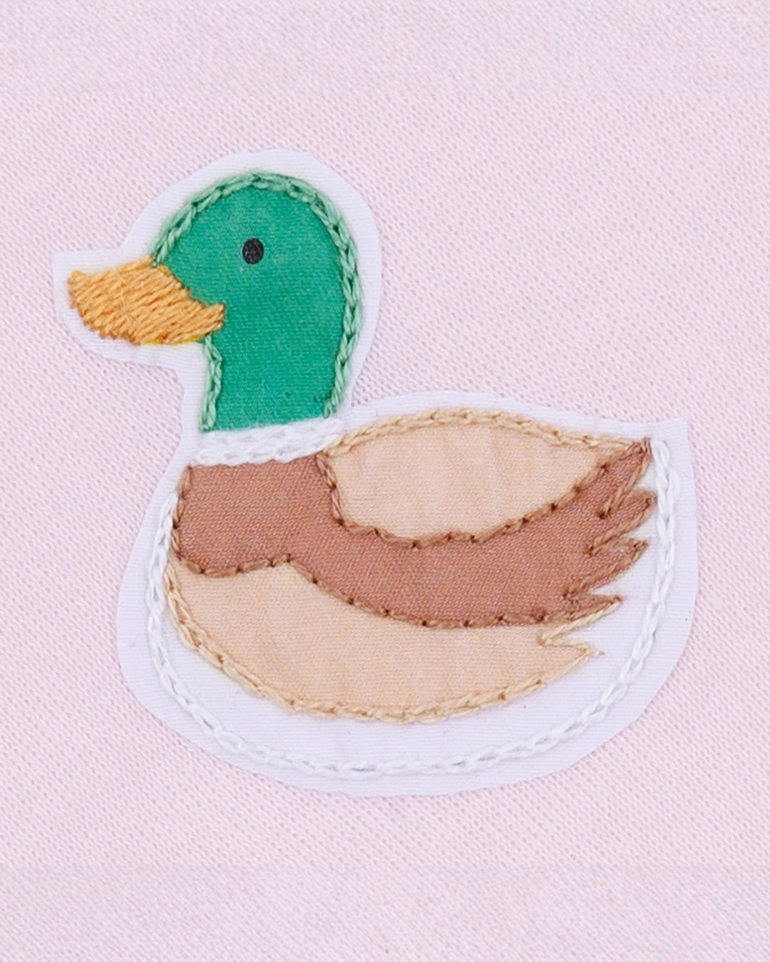 Fabric patch of a duck on a pink background
