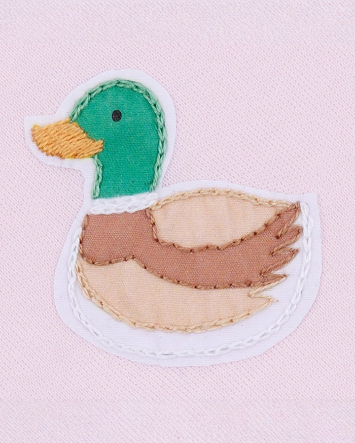 Fabric patch of a duck on a pink background