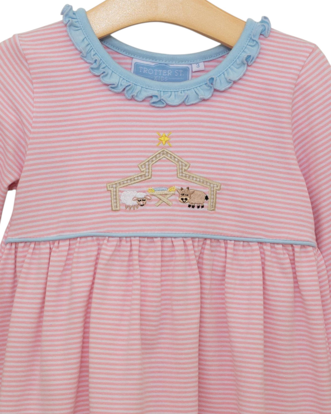 Pink striped dress with blue collar and farm animal design on a hanger