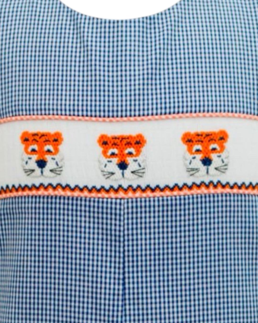 Blue checkered fabric with embroidered orange tigers on a white background
