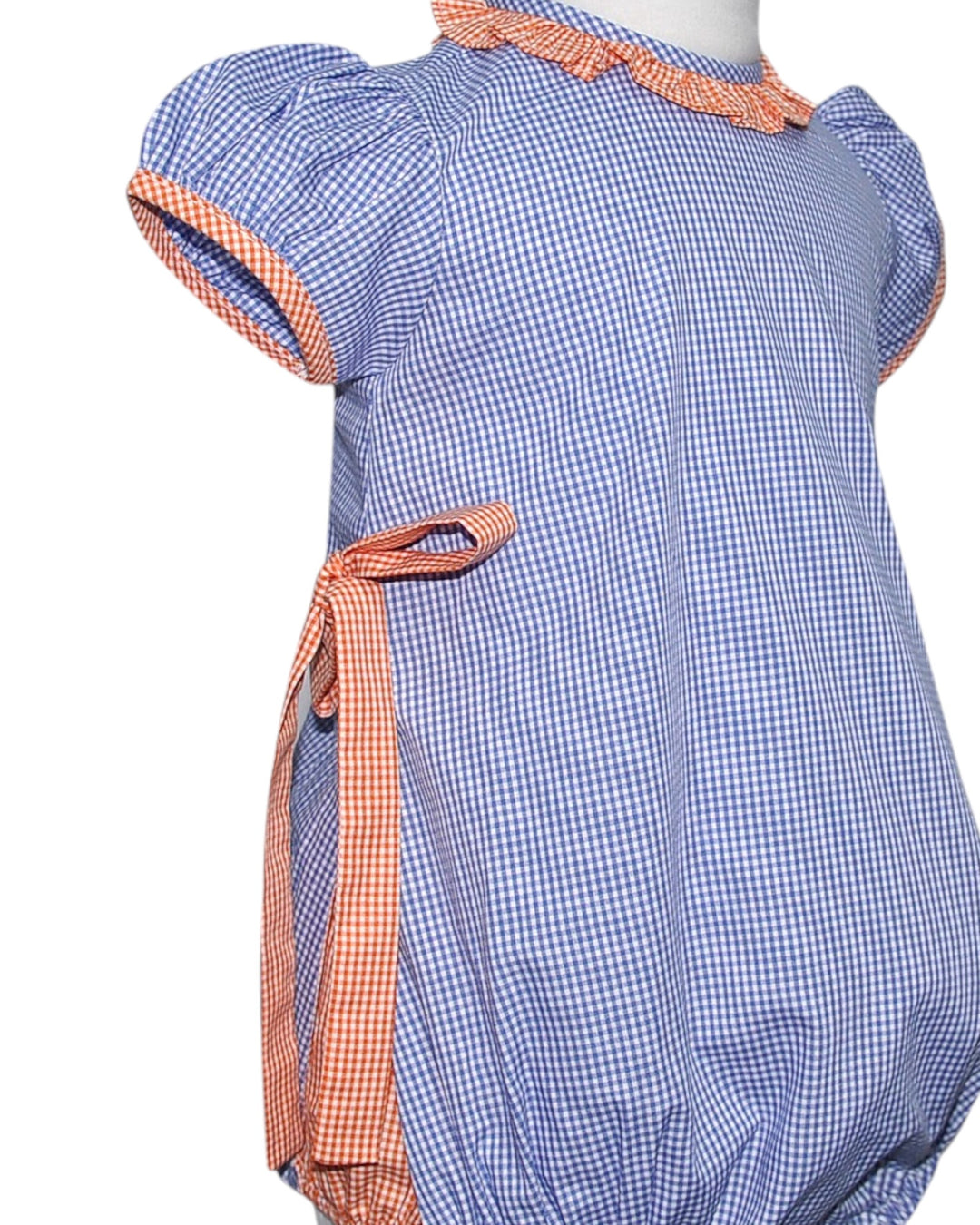 Blue checkered dress with orange trim on a white background