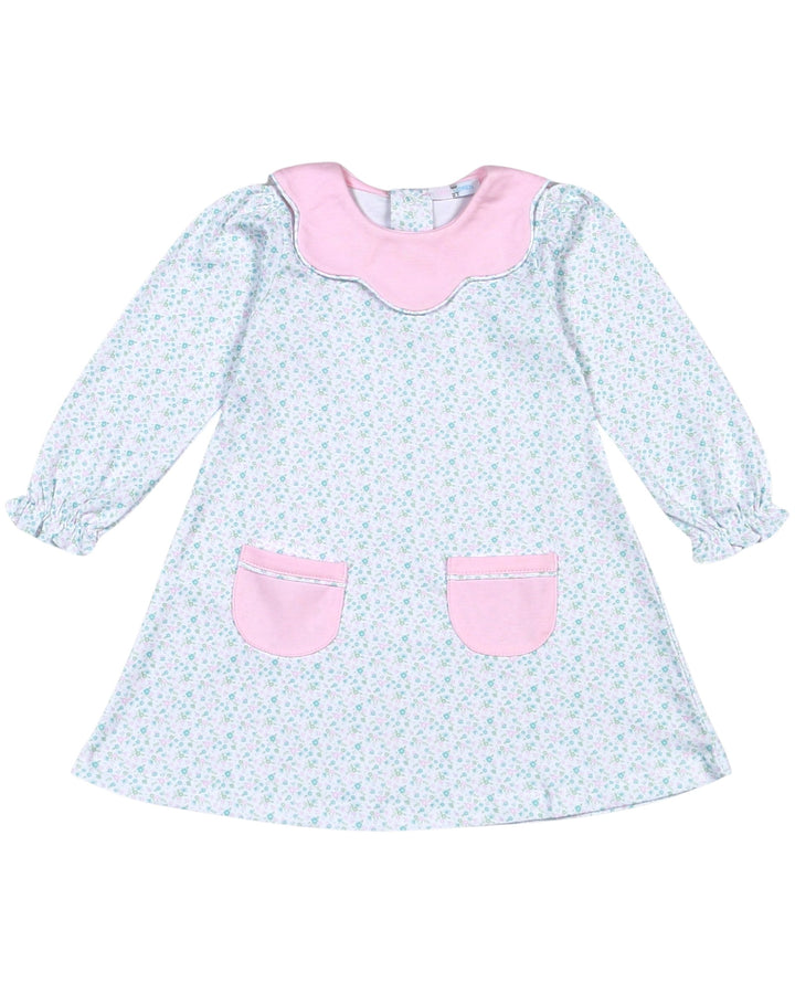 Children's dress with pink collar and pockets on a white background
