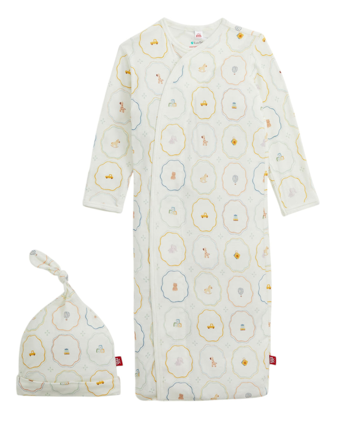 A baby sleep sack and matching knotted beanie set in a warm off-white cotton muslin fabric, both featuring a repeating pattern of scalloped hexagonal circles in yellow, blue, and gray with tiny illustrated characters inside, that store