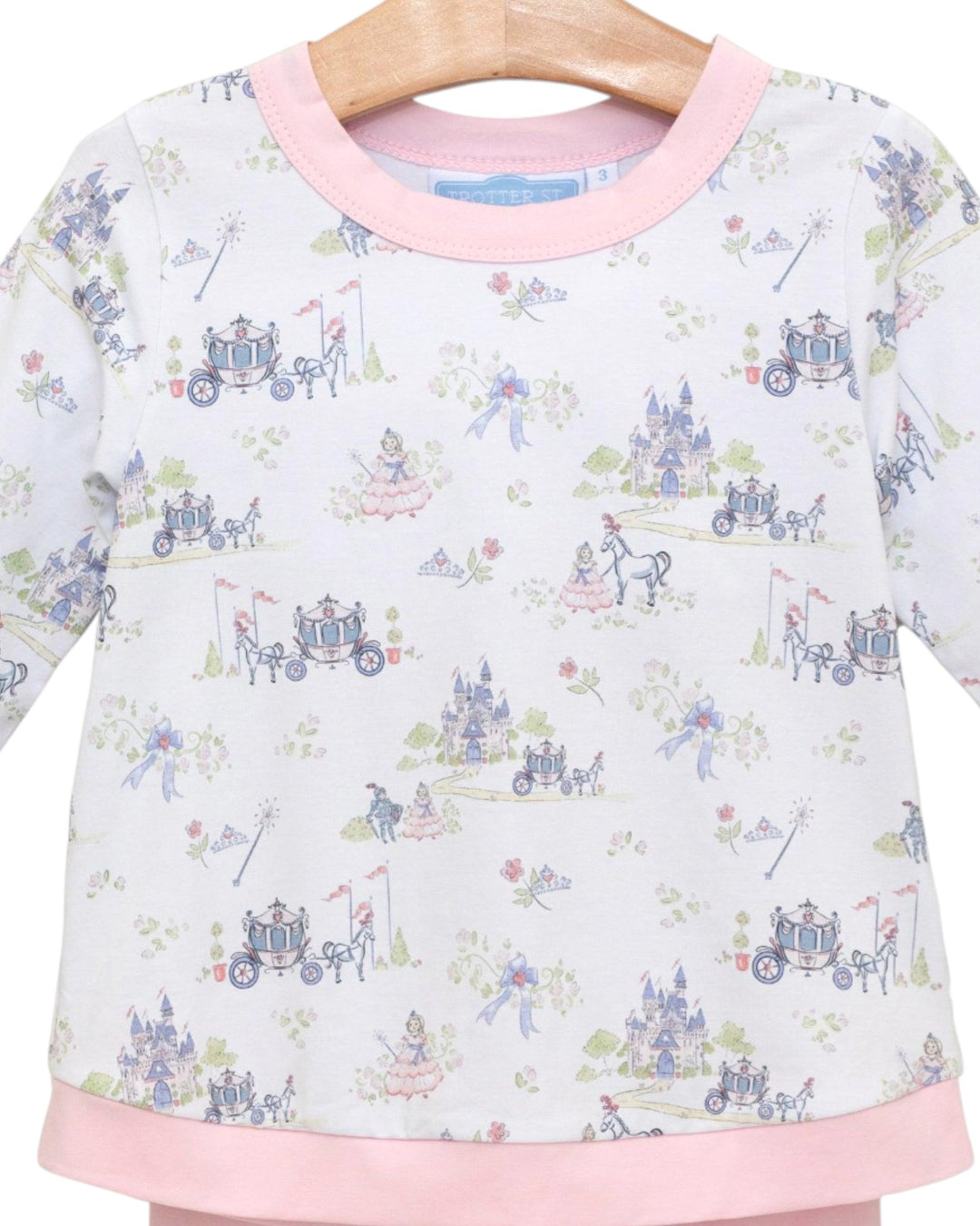 Children's outfit with fairy tale carriage print on a white background