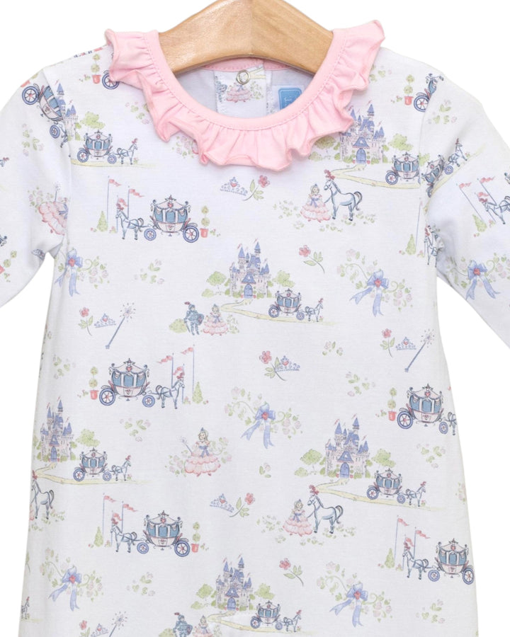 Children's dress with fairy tale carriage print and pink ruffled collar on a hanger.