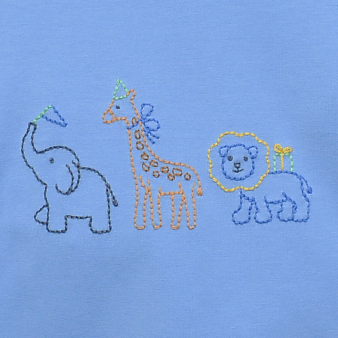 Embroidered design of an elephant, giraffe, and lion on a blue fabric background, that store
