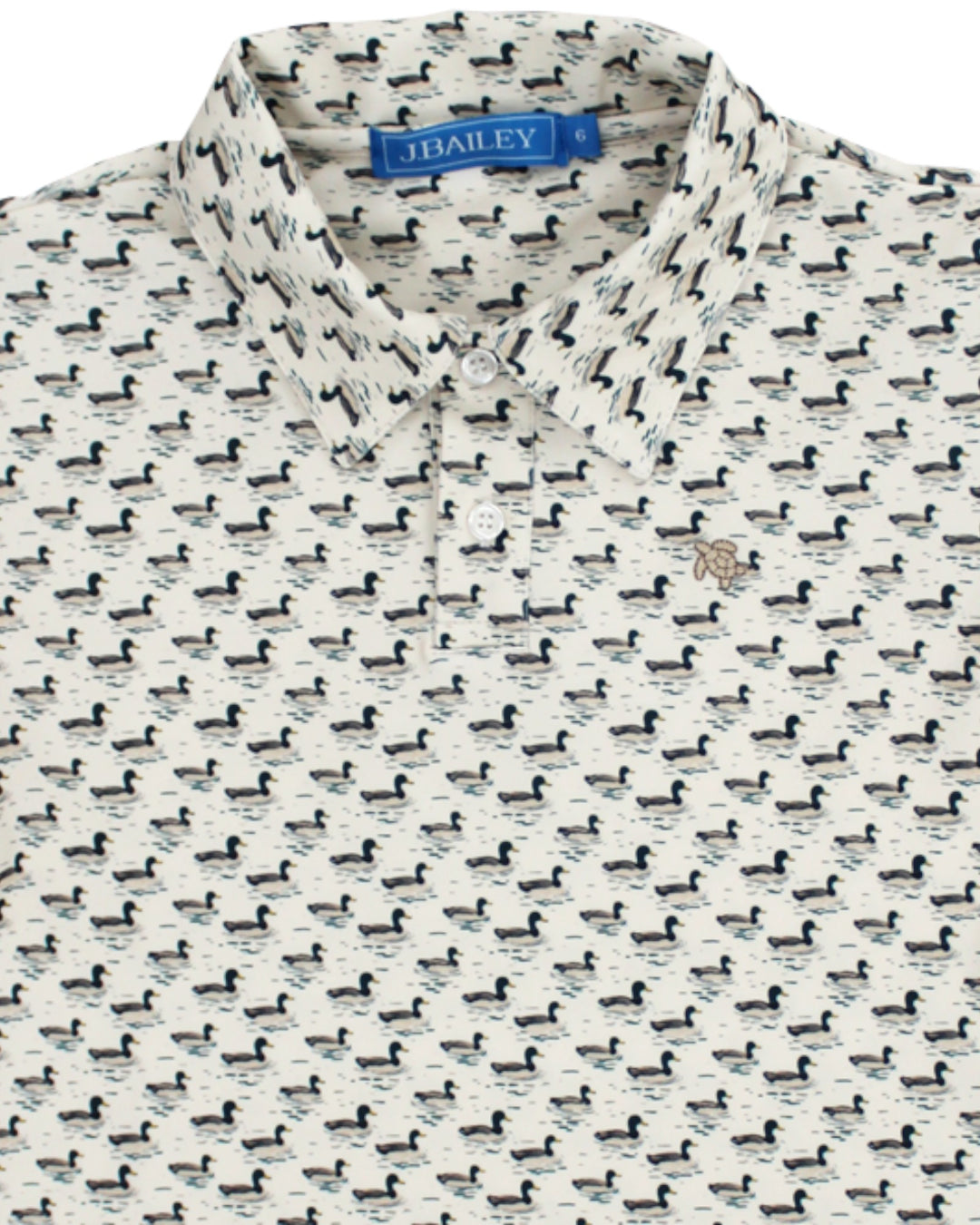 A close-up of a J.Bailey short-sleeve button-up shirt featuring an all-over black duck print on a warm off-white background, that store