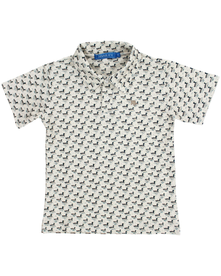 A short-sleeve polo shirt with an all-over repeating black dog print on a white background, featuring a small embroidered polo player logo on the chest, that store