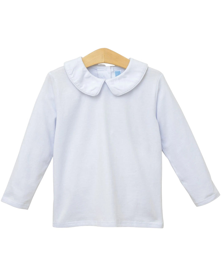 A white long-sleeve baby top with a Peter Pan collar, displayed on a wooden hanger against a plain white background, that store