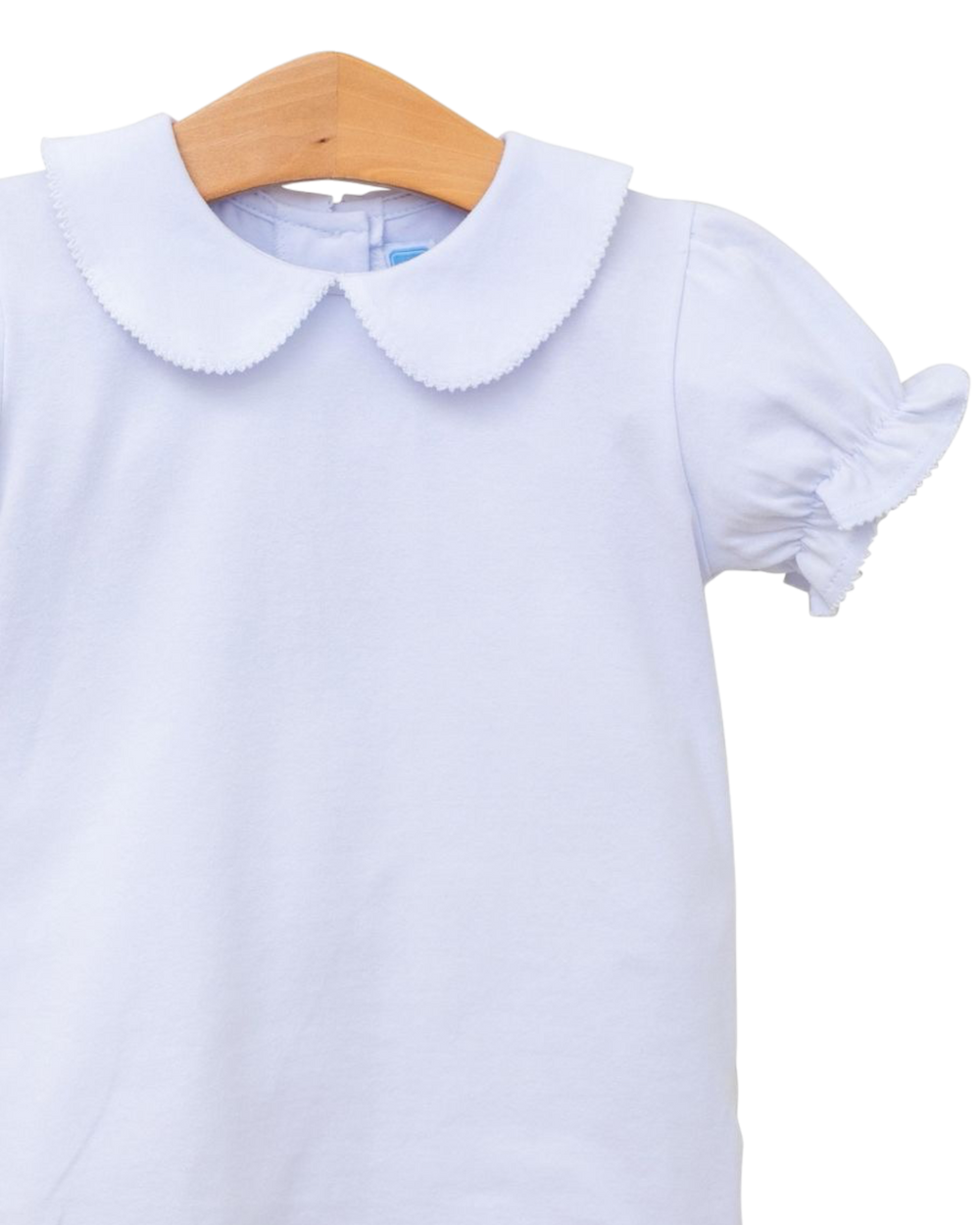 Light blue shirt with a collar on a wooden hanger against a white background
