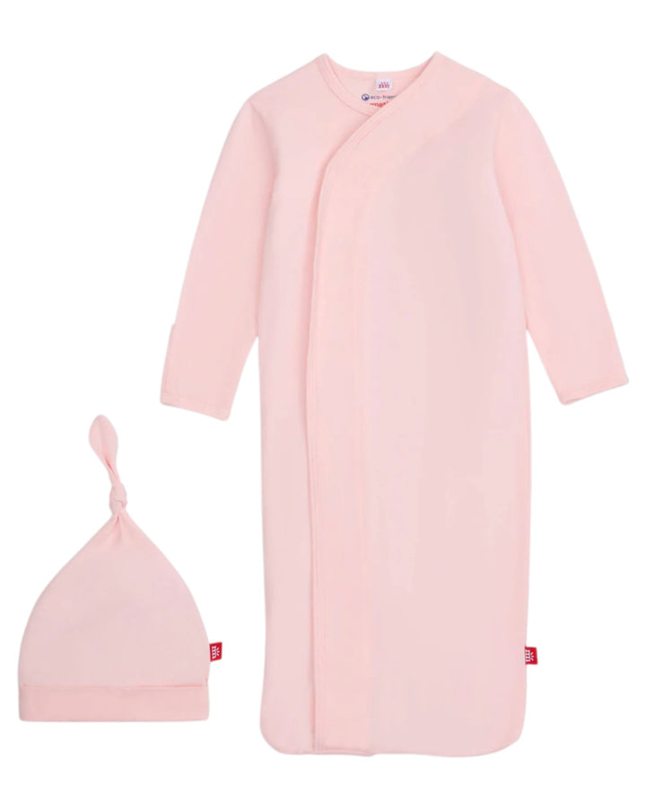 Pink baby gown and hat set on a white background