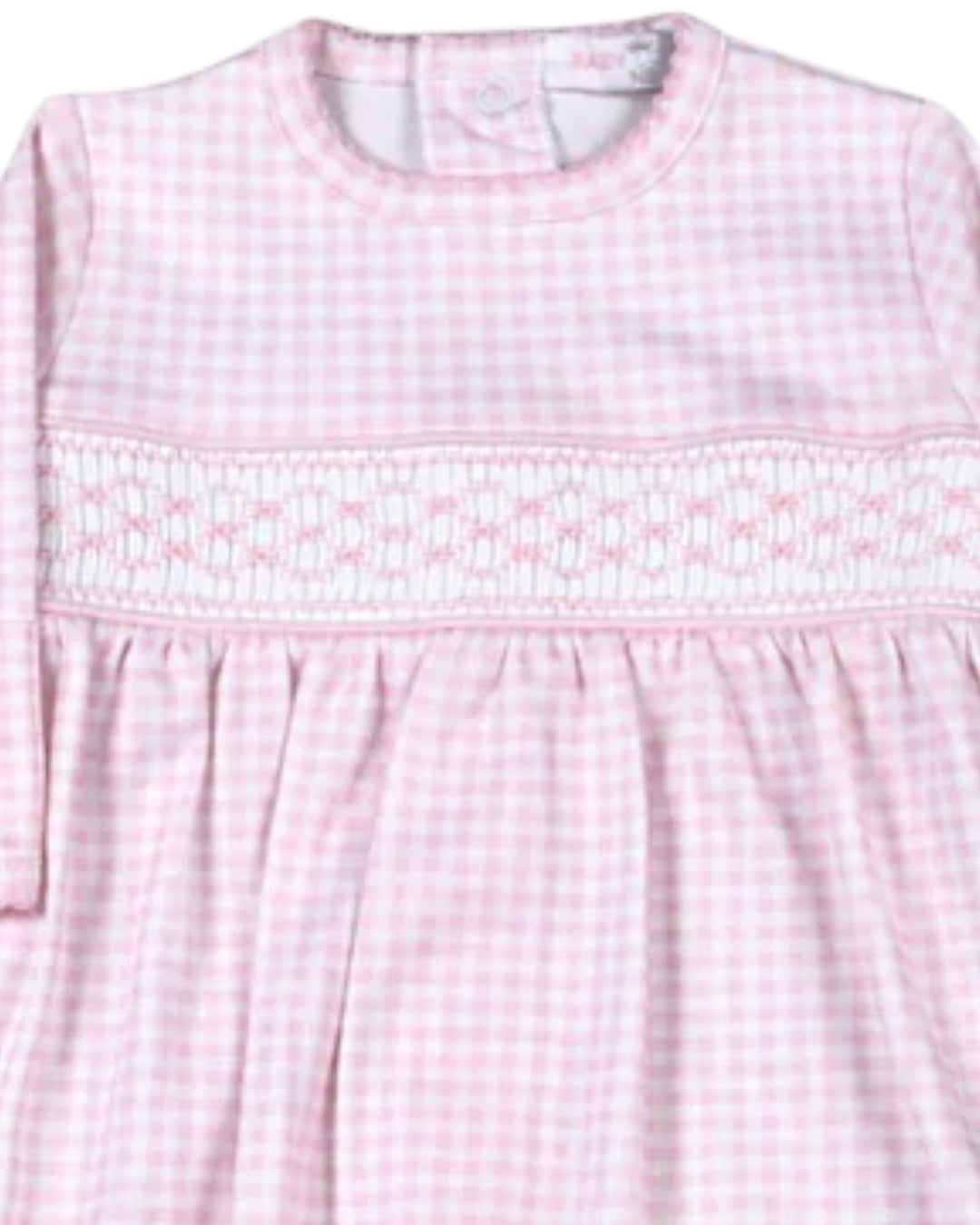 A close-up of a pink and white gingham dress with a smocked chest panel and long sleeves, that store