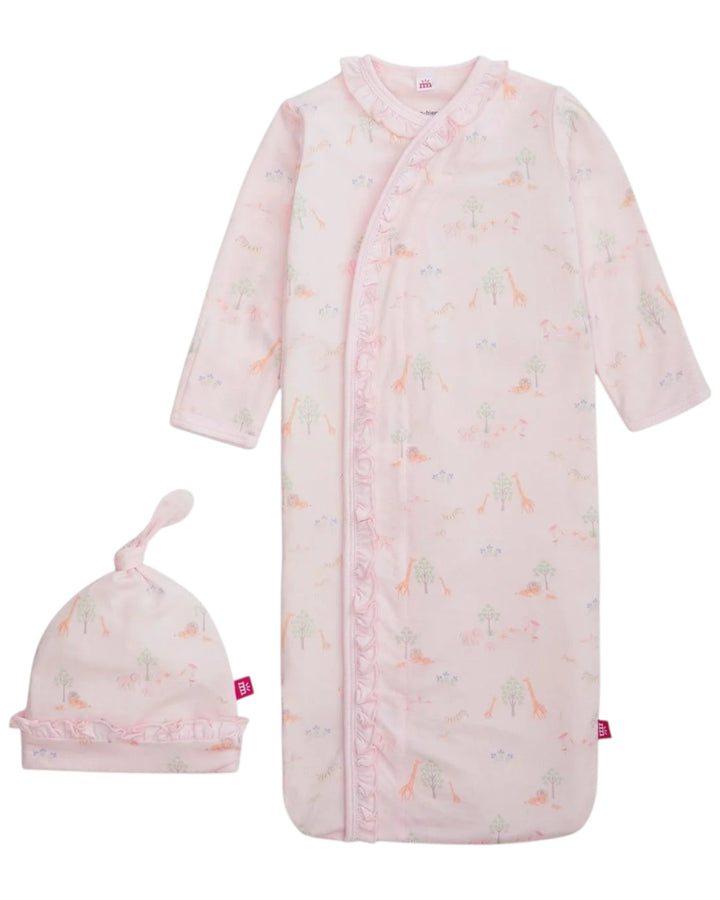 Baby pink sleeper with dinosaur pattern and matching hat on a white background