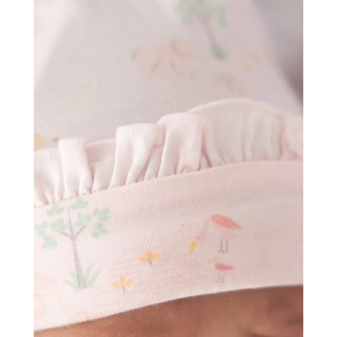 Close-up of a pink fabric with subtle floral patterns on a soft focus background