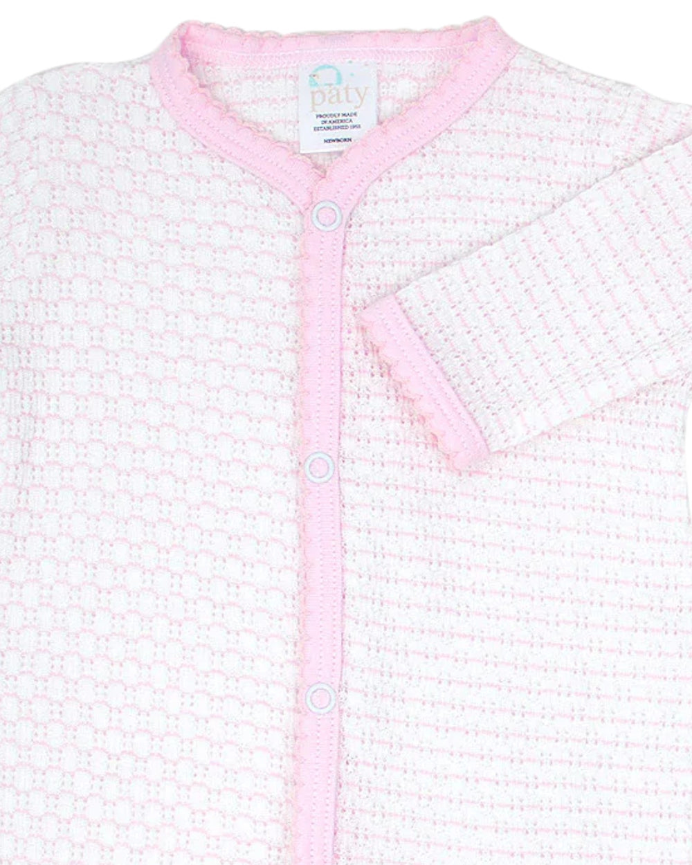 Baby cardigan with pink trim on a white background