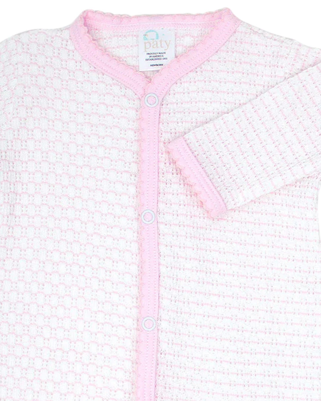 Baby cardigan with pink trim on a white background