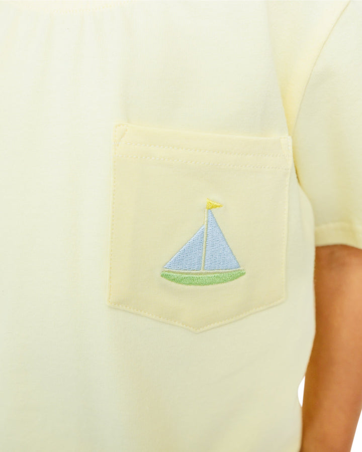 Yellow shirt with a sailboat design on a pocket, that store