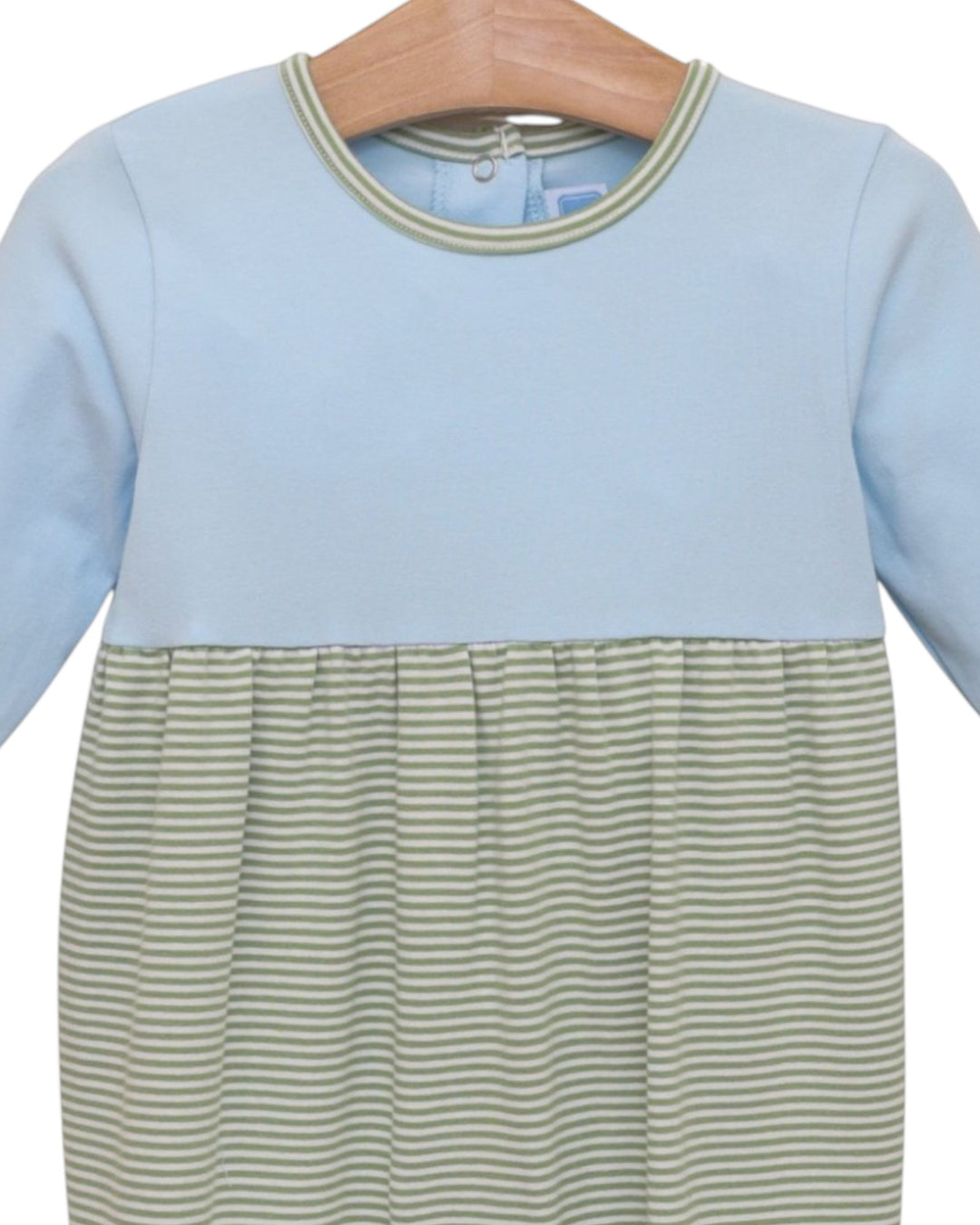 A long-sleeve baby dress with a solid light blue upper bodice and a green and white striped lower skirt, hanging on a wooden hanger against a white background, that store