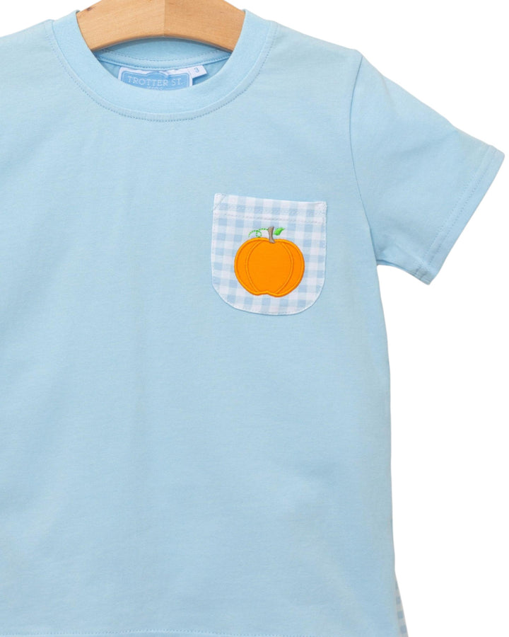Light blue t-shirt with a checkered pocket featuring an orange design on a white background