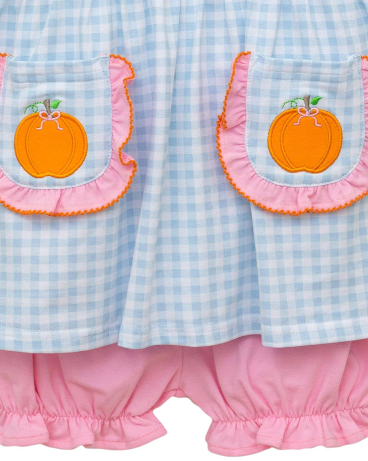 Children's dress with checkered pattern and pumpkin designs on a white background