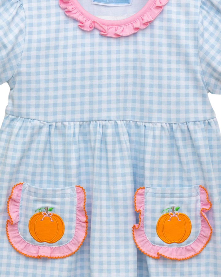 Light blue checkered dress with pink ruffled collar and orange pumpkin appliqués on a white background
