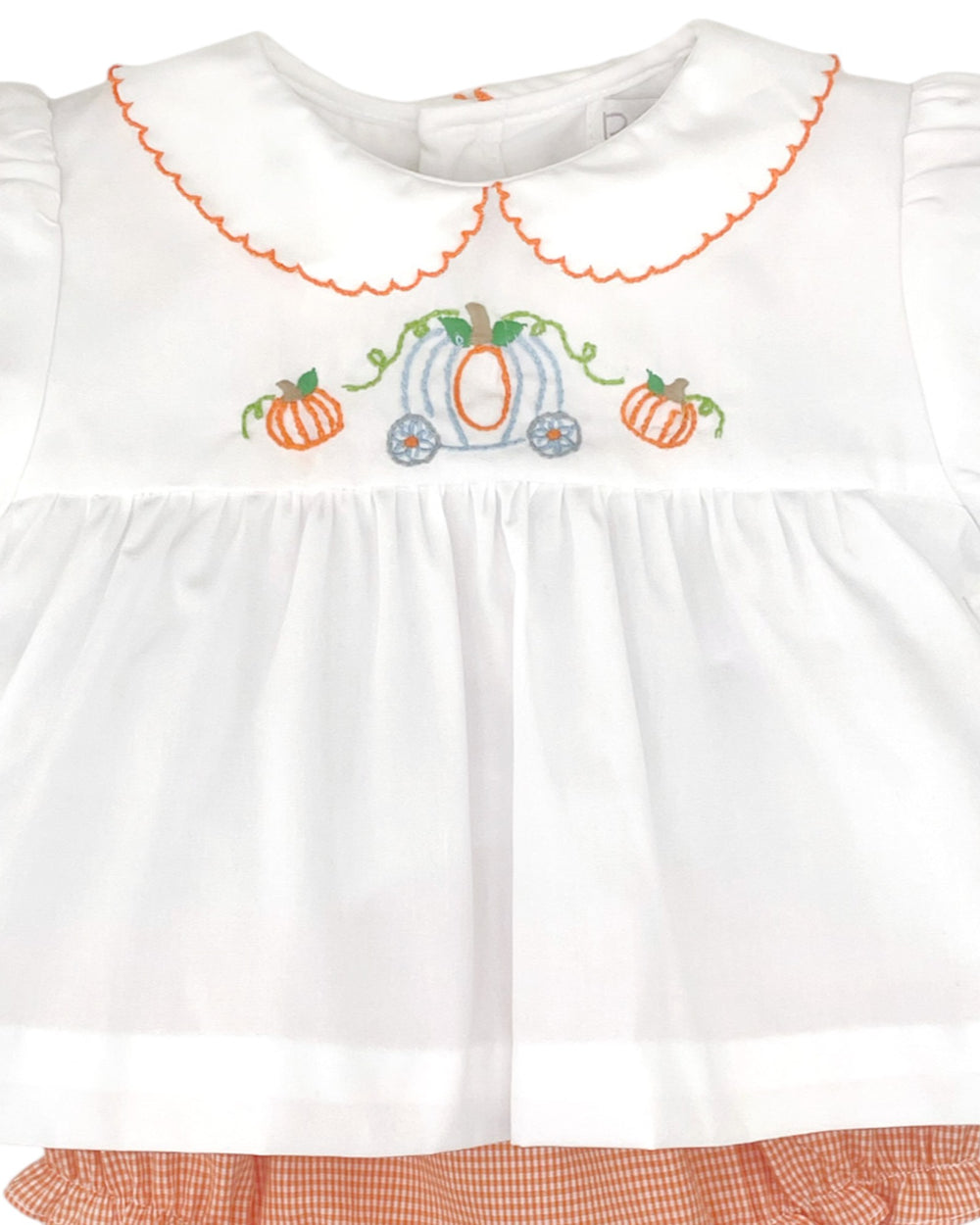 White blouse with orange embroidery of a pumpkin and carriage on a white background
