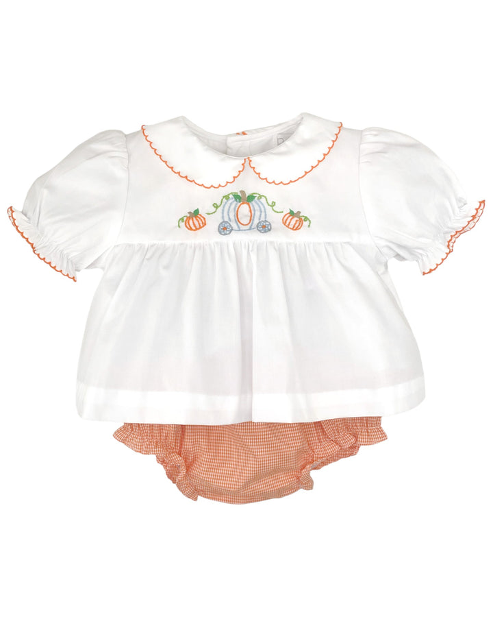 Baby girl's outfit with white top and orange bloomers on a white background
