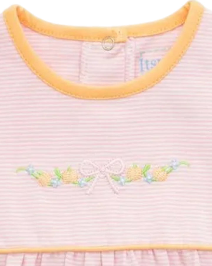 Close-up of a baby dress with light pink and white horizontal stripes, a yellow-orange crew neck trim, and a floral embroidered motif with a bow on the chest, that store