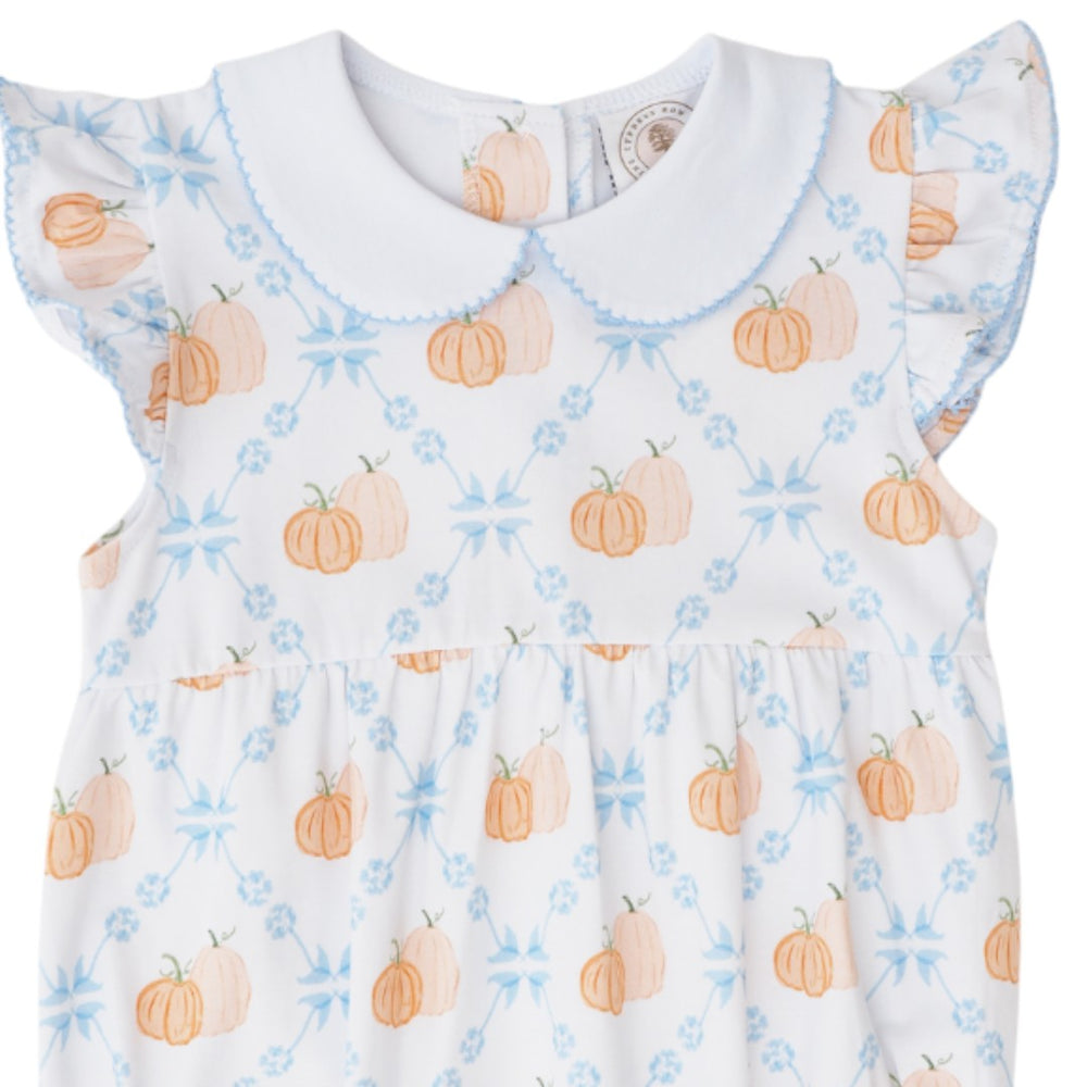 A white baby dress with a Peter Pan collar, ruffled sleeves, and an all-over print of orange pumpkins and light blue floral motifs, that store