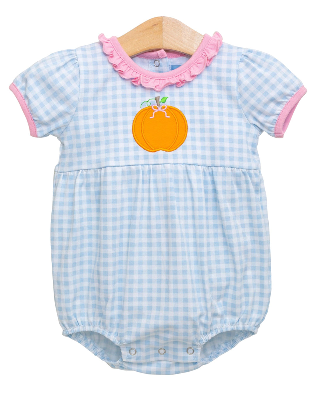 Baby romper with blue checkered pattern and pink trim on a white background