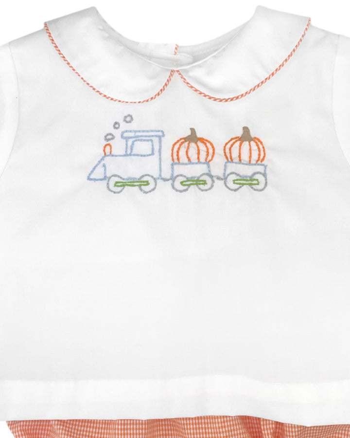 White sleeveless top with embroidered train and pumpkins design on a white background