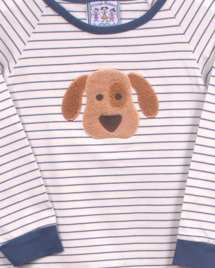 A close-up of a baby long-sleeve shirt with navy blue and white horizontal stripes, featuring a brown plush dog face applique on the chest and navy blue ribbed collar and cuffs, that store