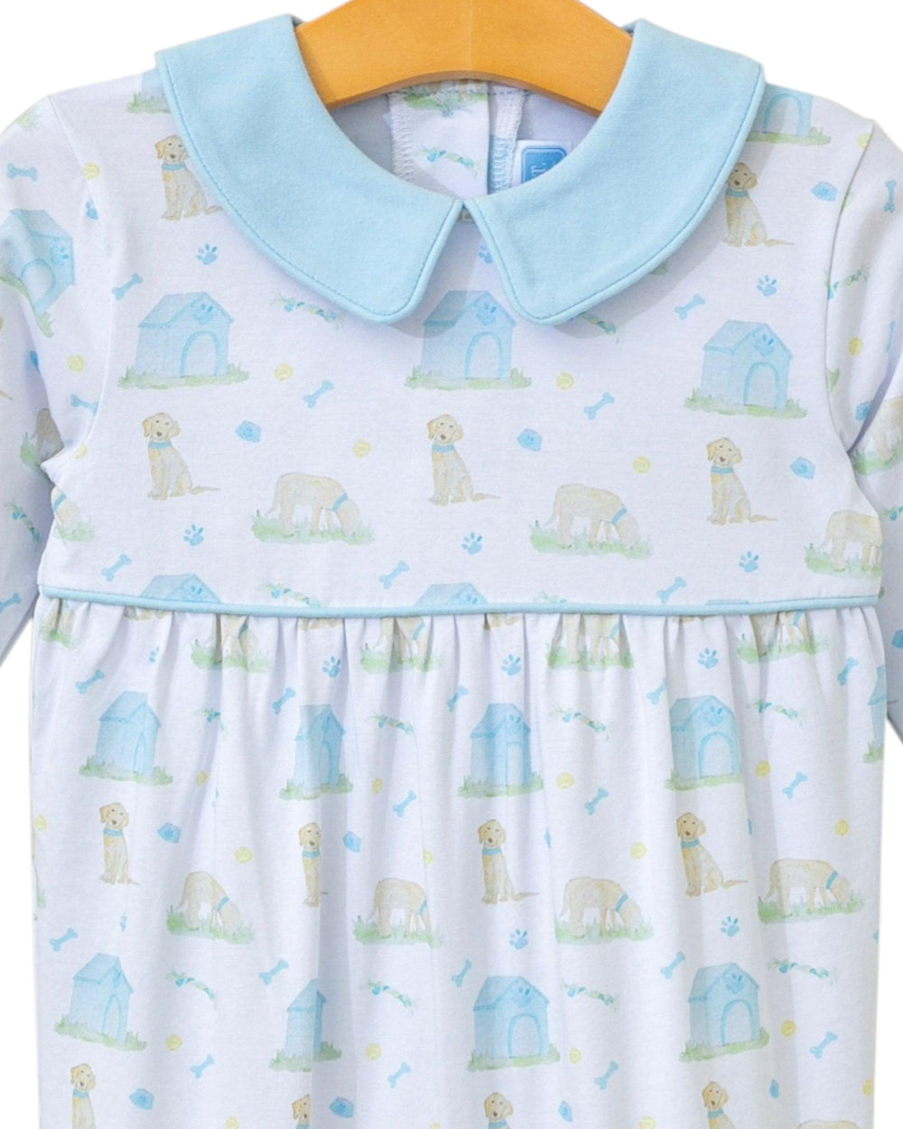 Children's dress with dog pattern and light blue collar on a hanger