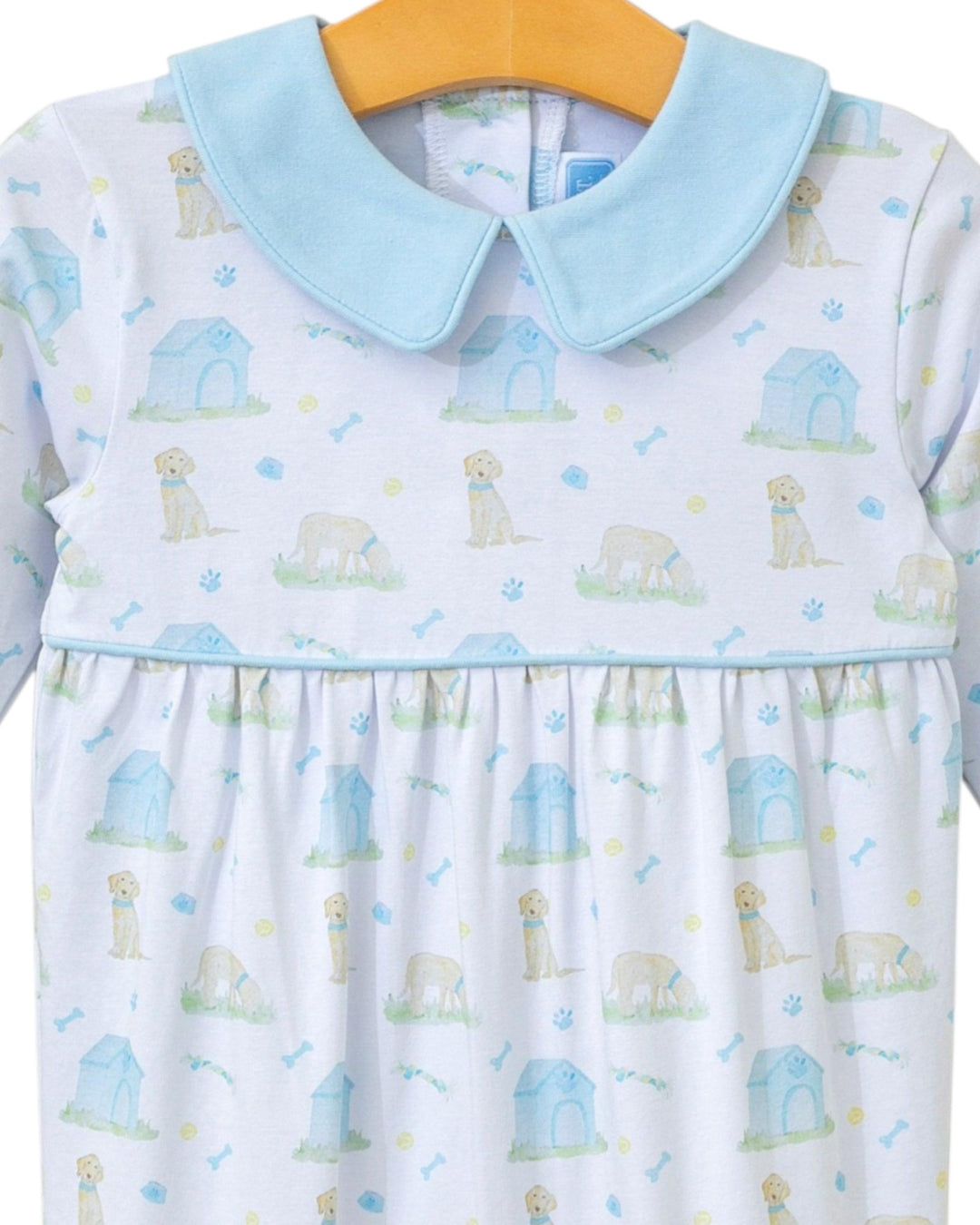 Children's dress with dog pattern and light blue collar on a hanger