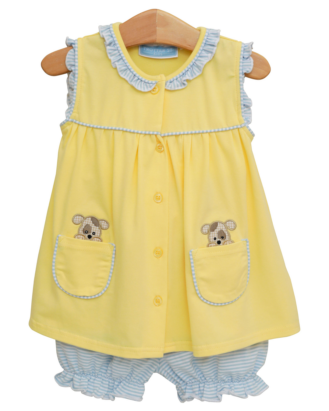 Yellow baby dress with puppy designs on a hanger against a white background
