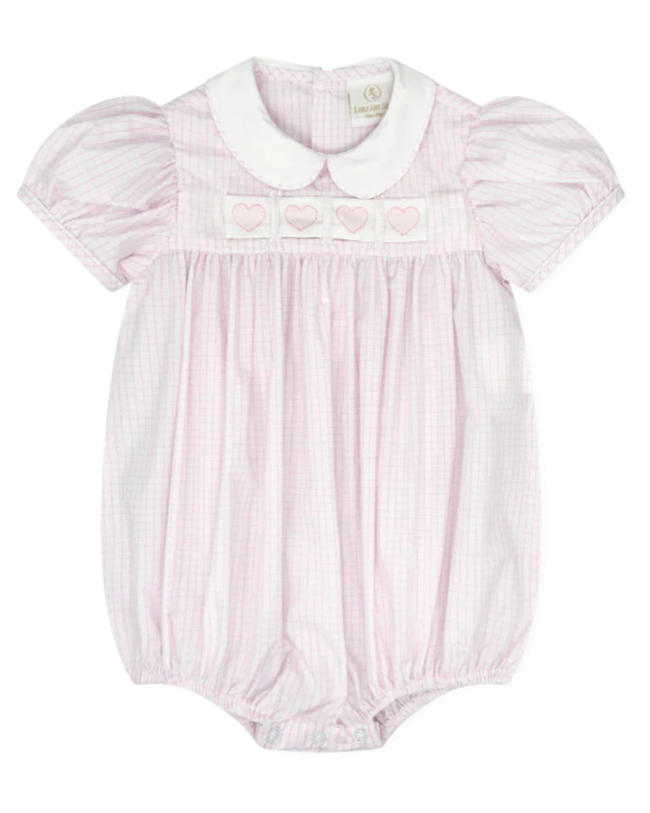 Pink baby romper with ruffled collar on a white background