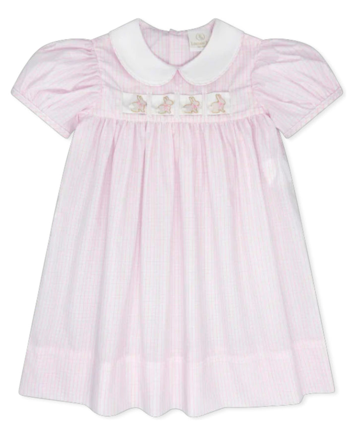 Pink dress with white collar and embroidered details on a white background